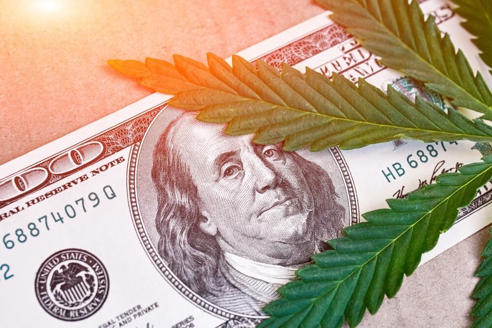 Cannabis banking challenges - 100 dollar bill with marijuana leaf
